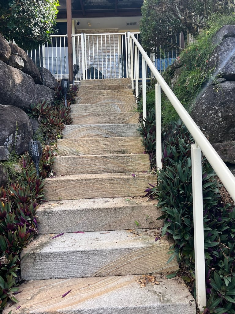 Clean boardwalk with white railings after pressure cleaning